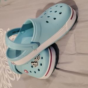 Kids teal Crocs, size 2, worn once. Includes the 46 charms.